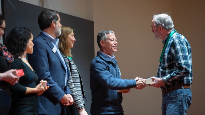 Rick Burgess congratulates Nick Van Eck,  on winning a Sustainability Champion award.