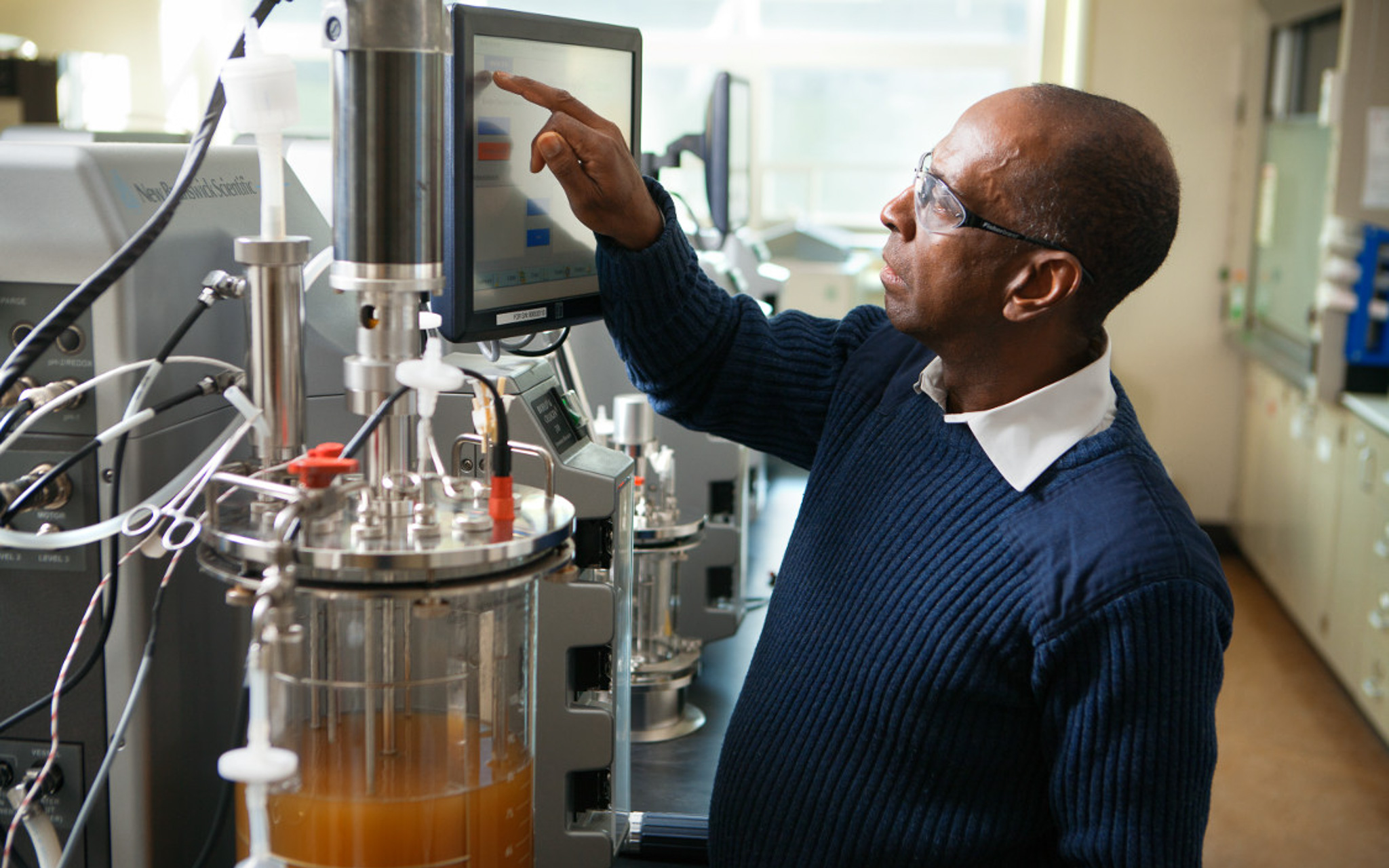 Researcher demonstrating technology and equipment in the Biofuels Research Lab