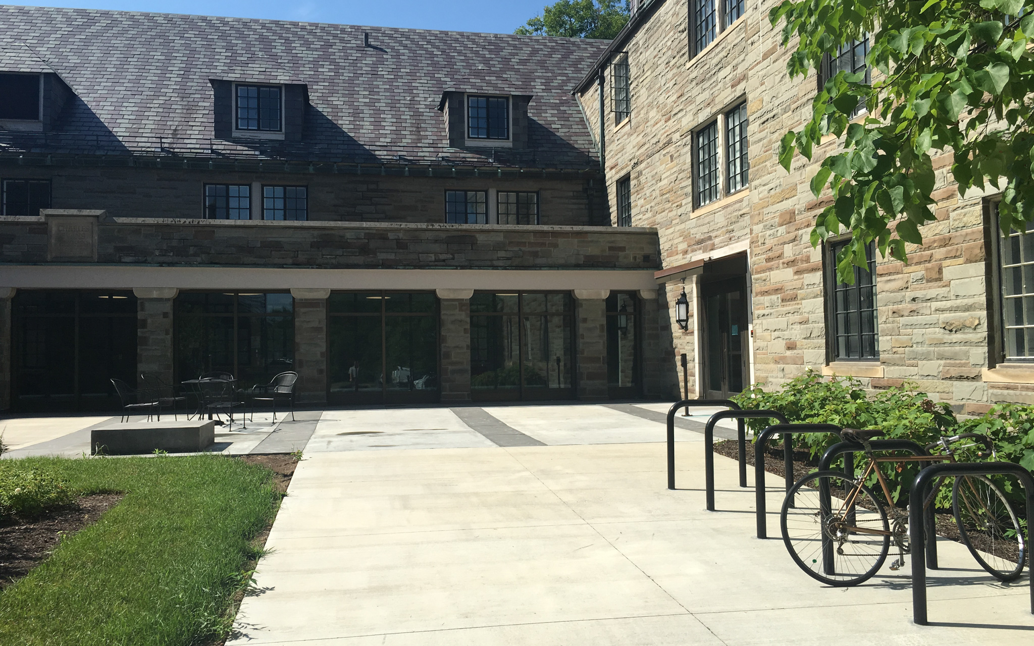 Bike rack and outdoor seating options at Hughes Hall