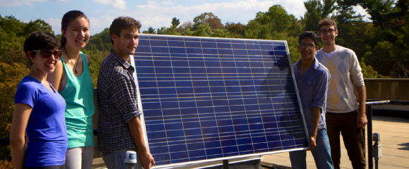 Team of students holding a solar panel