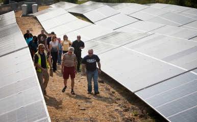 Group standing near Cornell solar array