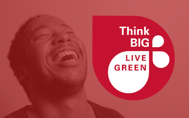 Think Big Live Green on red logo with laughing man in background