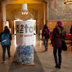 An oversized water bottle with facts on waste encourages passerbys to rethink plastic bottled water use