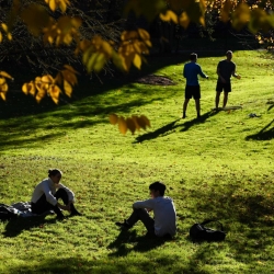 Students relax in the clearing by Sage Hall after class in October.