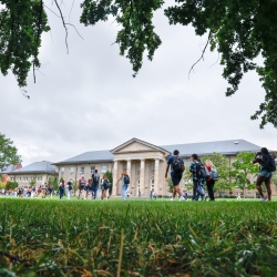 Students pass Goldwin-Smith Hall on the Arts Quad