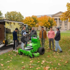 Students and staff standing near the trailer they built
