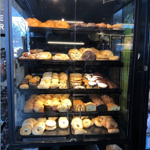 Case of baked goods in a dining location without individual plastic