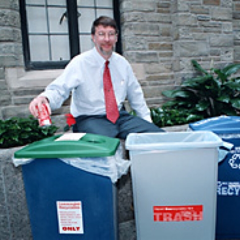 Walter Smithers, university solid waste manager, shows off recycling bins in the Law School atrium.
