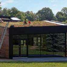 Two employees doing work on the green roof of the Botanic Garden Welcome Center.