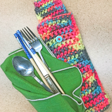 Crocheted " utensil cozy" with spoon, knife and fork.