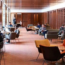 Law students sit on couches and at tables inside the Law Learning Center.