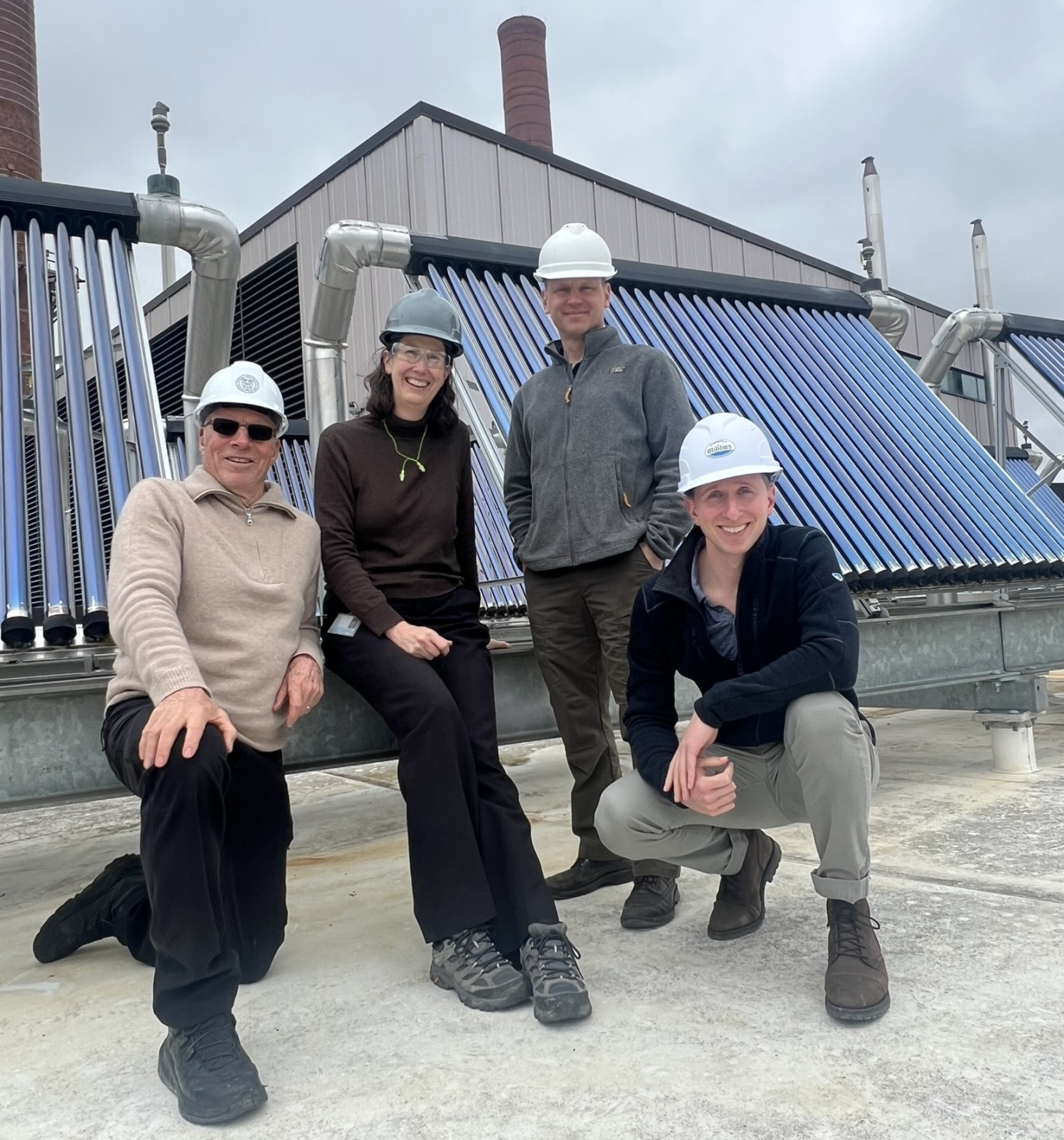 Mark Howe, former director of Utility Distribution and Energy Management, Sarah Carson, and Steve Beyers, energy specialist, in front of the Cornell University Borehole Observatory in summer 2022. 