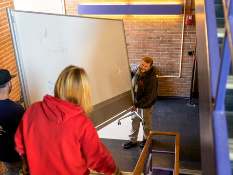 Staff repurposing a whiteboard 