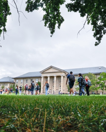 Students pass Goldwin-Smith Hall on the Arts Quad